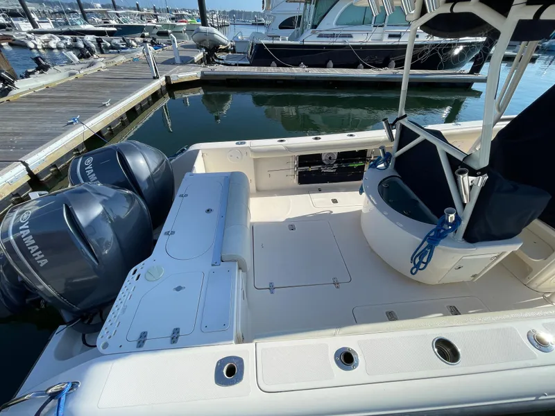 Slide: The Image of 2011 Pursuit 280 Center Console boat with twin Yamaha engines docked at marina. - 7