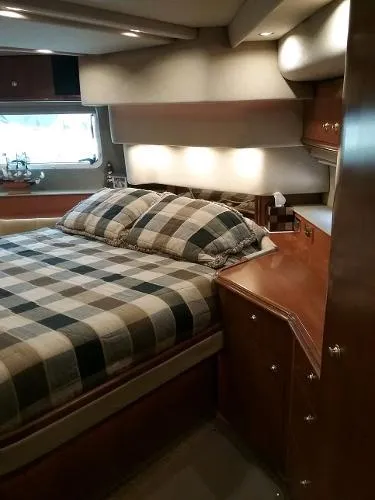 Slide: The Image of Luxurious bedroom in 2000 Cruisers Yachts 4450 Express Motoryacht with plaid bedding. - 23