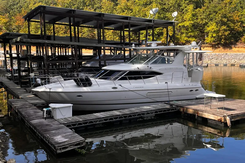 Slide: The Image of 2000 Cruisers Yachts 4450 Express Motoryacht docked at a marina. - 39