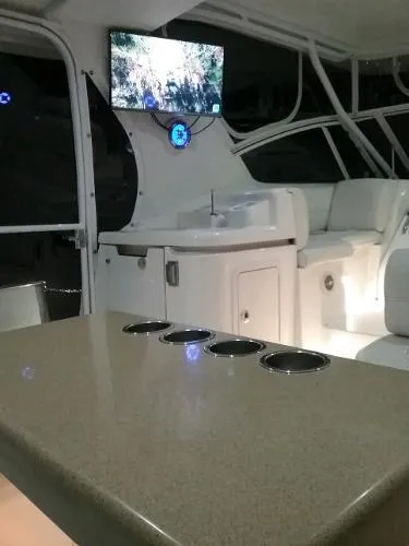 Slide: The Image of Interior of 2000 Cruisers Yachts 4450 Express Motoryacht with TV and seating area. - 5