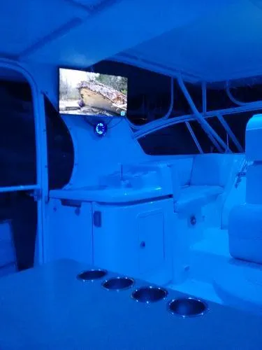 Slide: The Image of Interior of 2000 Cruisers Yachts 4450 Express Motoryacht with blue lighting and TV. - 9
