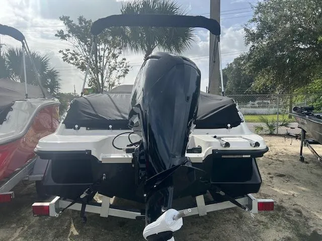 Slide: The Image of 2024 Bayliner Element M19 boat rear view with outboard motor. - 2