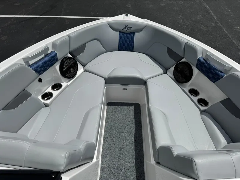 Slide: The Image of 2023 MasterCraft XT23 boat interior with gray seating and blue accents. - 10