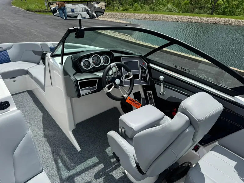 Slide: The Image of 2023 MasterCraft XT23 boat interior with modern dashboard and steering wheel. - 11