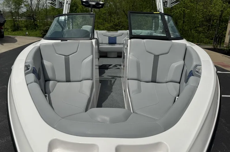 Slide: The Image of 2023 MasterCraft XT23 boat interior with sleek gray seating and modern design. - 8