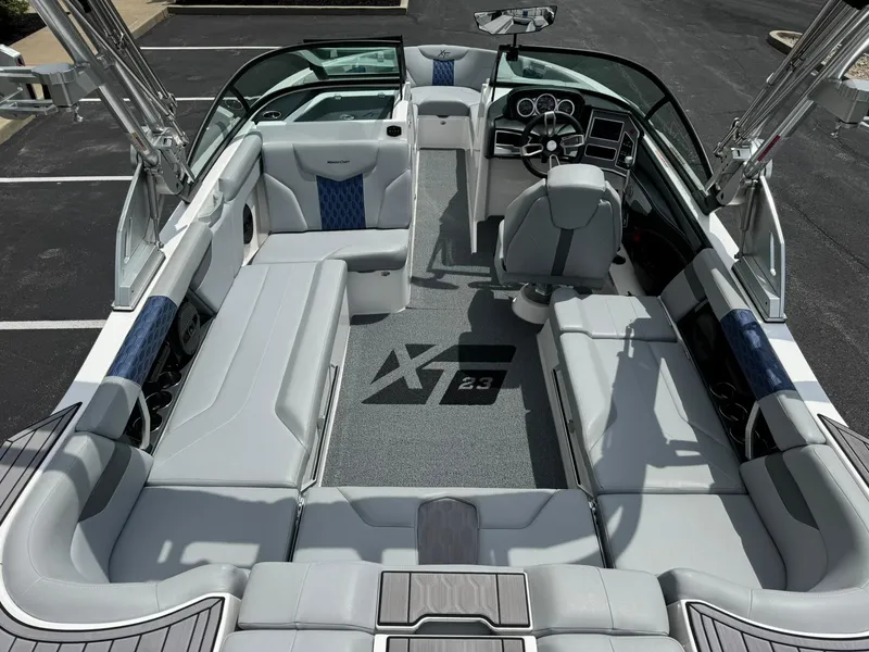 Slide: The Image of 2023 MasterCraft XT23 boat interior with luxurious seating and modern dashboard. - 9