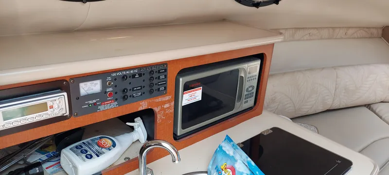 Slide: The Image of 2005 Chaparral Signature 240 interior with microwave, control panel, and sink. - 11