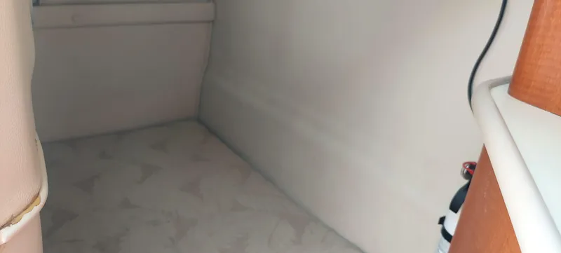 Slide: The Image of Interior cabin of 2005 Chaparral Signature 240 boat with beige upholstery. - 16