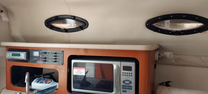 Slide: The Image of Interior of 2005 Chaparral Signature 240 with microwave and control panel. - 18