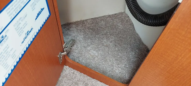 Slide: The Image of 2005 Chaparral Signature 240 interior storage compartment with carpeted floor. - 19