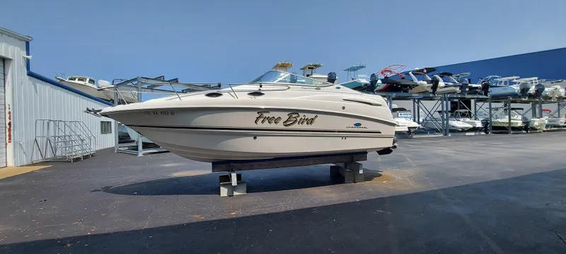 Slide: The Image of 2005 Chaparral Signature 240 boat named Free Bird on a stand in a marina. - 2