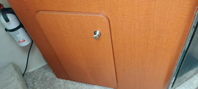 Slide: The Image of Wooden cabinet door inside a 2005 Chaparral Signature 240 boat. - 20