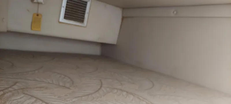 Slide: The Image of Interior cabin of a 2005 Chaparral Signature 240 boat with patterned upholstery. - 21