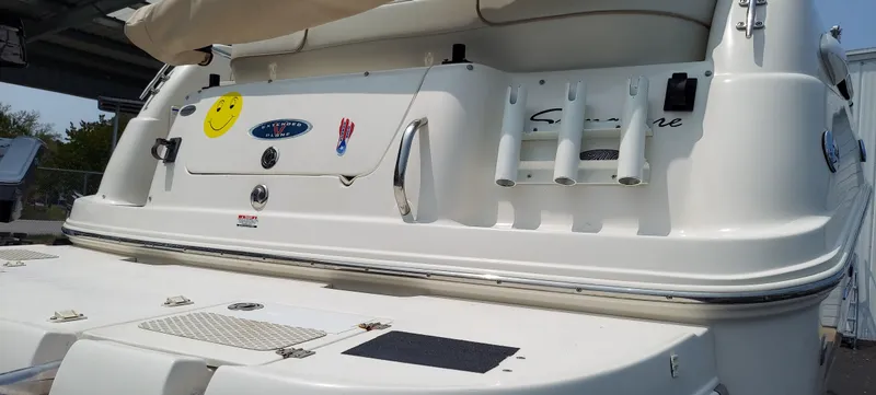 Slide: The Image of 2005 Chaparral Signature 240 boat stern with rod holders and smiley face sticker. - 5