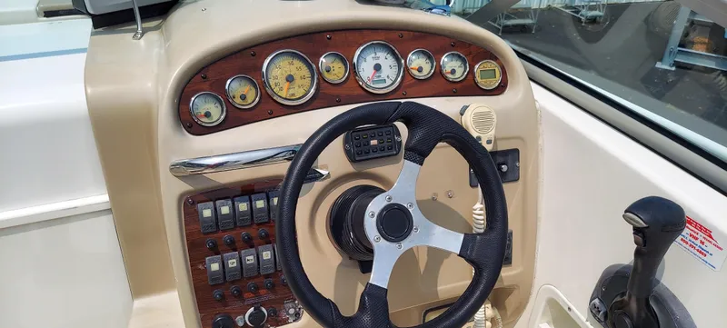 Slide: The Image of 2005 Chaparral Signature 240 boat dashboard with steering wheel and control panel. - 8