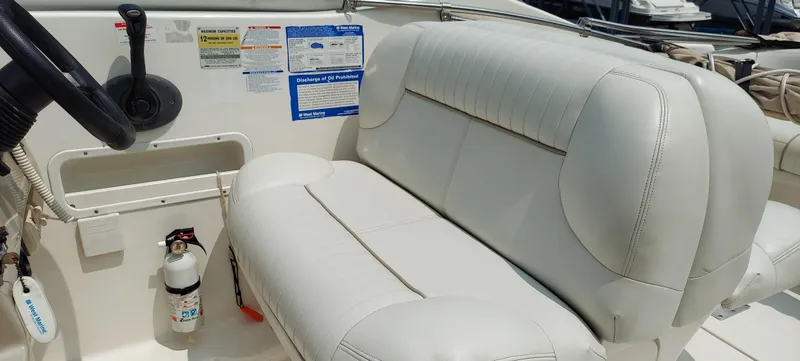 Slide: The Image of 2005 Chaparral Signature 240 boat interior with white leather seating and steering wheel. - 9