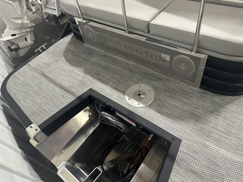 Slide: The Image of 2024 Bennington 24LXS boat interior with storage compartment and seating. - 10