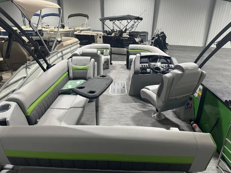 Slide: The Image of 2024 Bennington 24LXS pontoon boat interior with gray and green seating. - 11