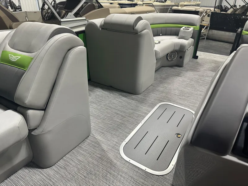 Slide: The Image of 2024 Bennington 24LXS pontoon boat interior with gray and green seating. - 14