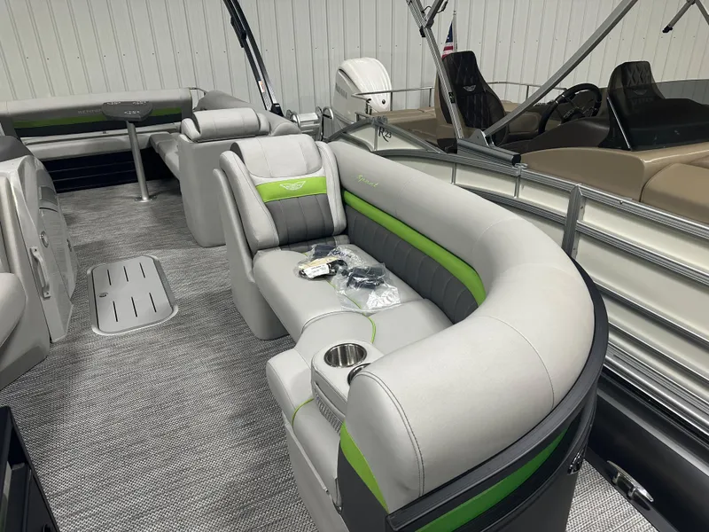 Slide: The Image of 2024 Bennington 24LXS pontoon boat interior with gray and green seating. - 4