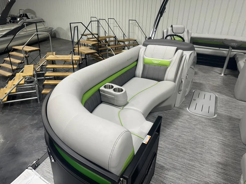 Slide: The Image of 2024 Bennington 24LXS pontoon boat interior with gray and green seating. - 5