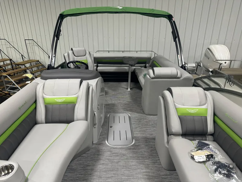 Slide: The Image of 2024 Bennington 24LXS pontoon boat with green and gray interior. - 6