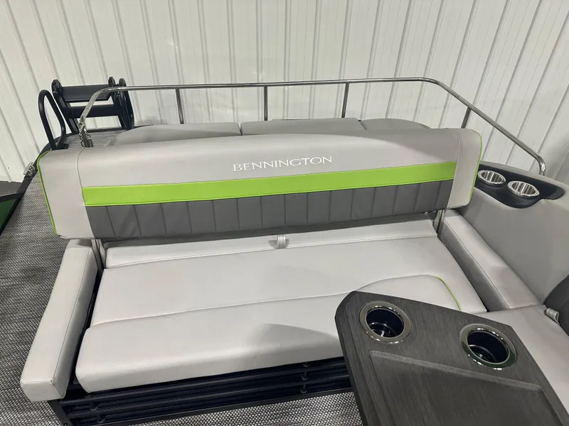 Slide: The Image of 2024 Bennington 24LXS boat interior with gray and green seating. - 8