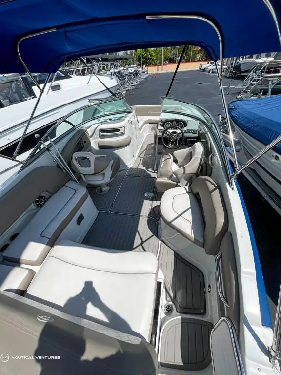 Slide: The Image of 2019 Crownline Eclipse E235 XS boat interior with blue canopy, docked. - 13