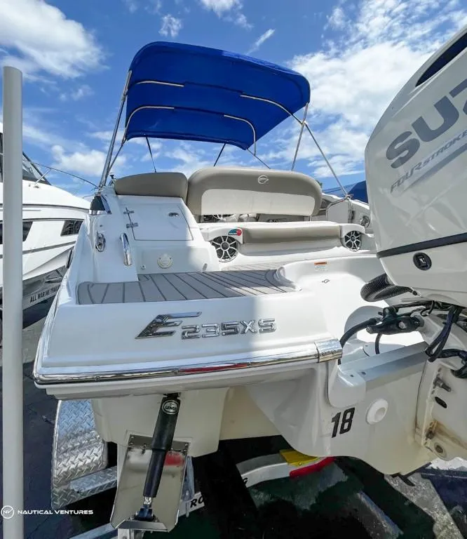 Slide: The Image of 2019 Crownline Eclipse E235 XS boat with Suzuki outboard motor, blue canopy, and spacious deck. - 14