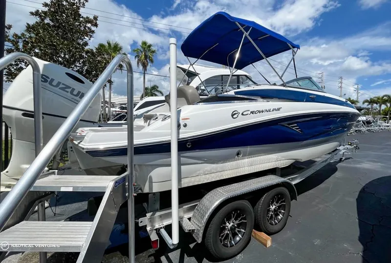 Slide: The Image of 2019 Crownline Eclipse E235 XS boat on trailer with blue canopy. - 4