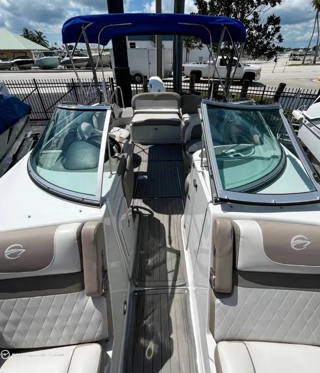 Slide: The Image of 2019 Crownline Eclipse E235 XS boat with blue canopy and spacious seating. - 8