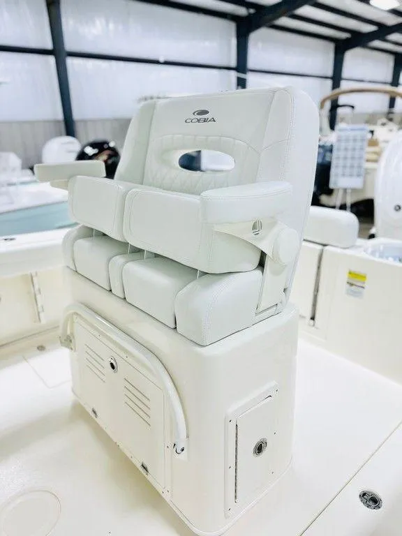 Slide: The Image of 2024 Cobia 240 CC boat seat in a showroom setting. - 12