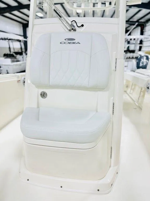 Slide: The Image of 2024 Cobia 240 CC boat seat in a showroom setting. - 17