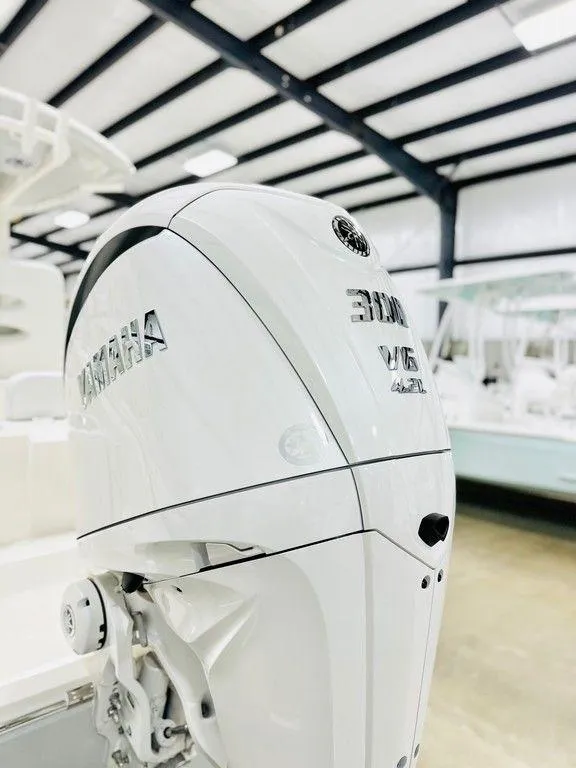 Slide: The Image of 2024 Cobia 240 CC with Yamaha outboard motor in showroom. - 4