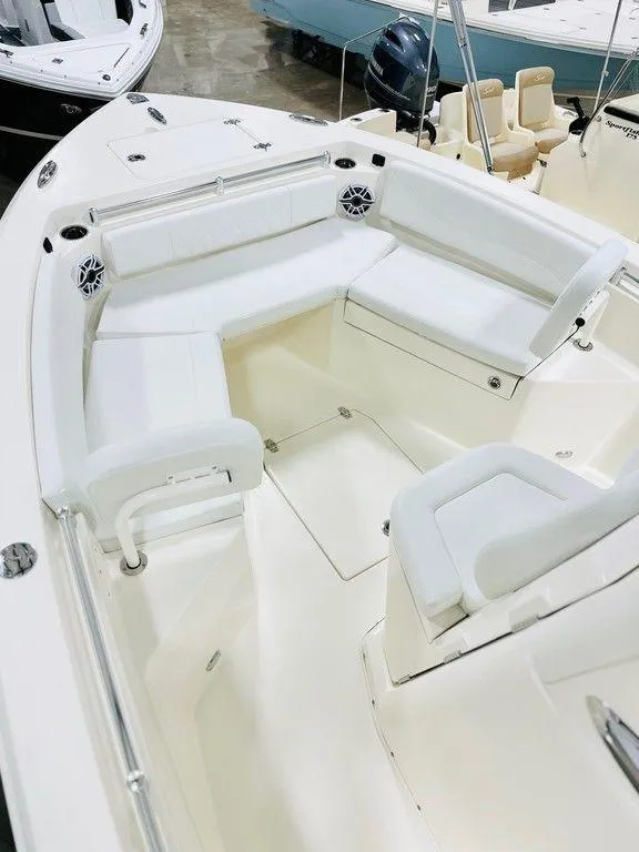 Slide: The Image of 2024 Cobia 240 CC boat with spacious white seating area. - 6