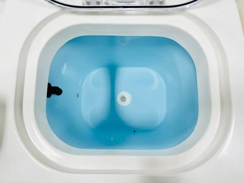 Slide: The Image of Livewell tank in 2024 Cobia 240 CC boat, filled with blue water. - 9