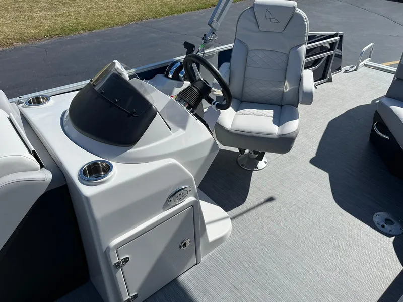 Slide: The Image of 2024 Lowe SS 210 boat interior with steering console and captain's chair. - 14