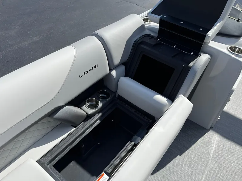 Slide: The Image of 2024 Lowe SS 210 boat interior with storage compartments and cup holders. - 19