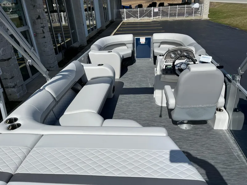 Slide: The Image of 2024 Lowe SS 210 pontoon boat with spacious seating and modern helm. - 5
