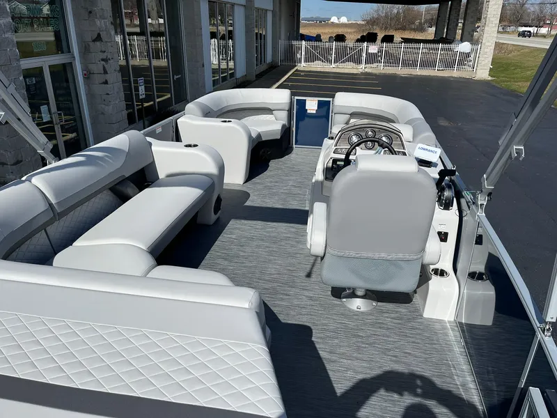Slide: The Image of 2024 Lowe SS 210 pontoon boat interior with spacious seating and modern helm. - 6