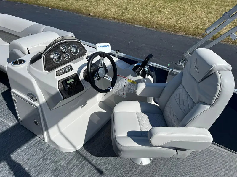 Slide: The Image of 2024 Lowe SS 210 boat cockpit with steering wheel and captain's chair. - 7