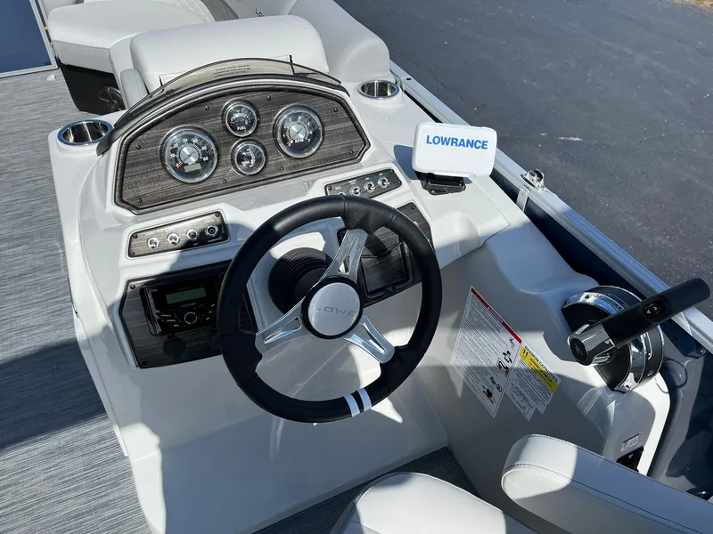 Slide: The Image of 2024 Lowe SS 210 boat dashboard with steering wheel and Lowrance navigation system. - 8