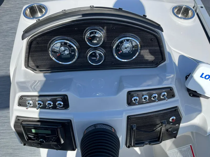 Slide: The Image of 2024 Lowe SS 210 boat dashboard with gauges and controls. - 9