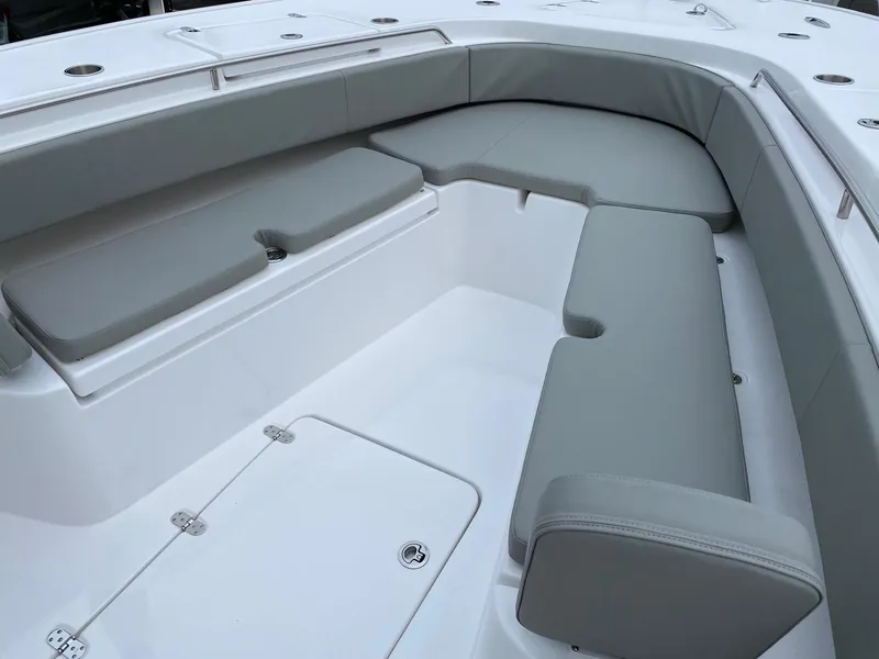 Slide: The Image of 2024 Cape Horn 36 XS boat interior with cushioned seating and storage compartments. - 11
