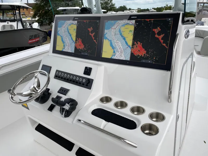 Slide: The Image of 2024 Cape Horn 36 XS boat console with dual navigation screens and steering wheel. - 8