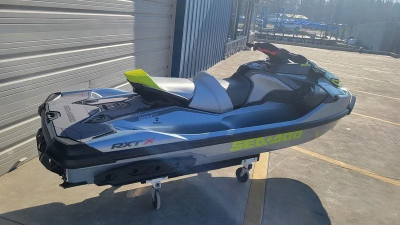 Slide: The Image of 2024 Sea-Doo RXT-X 325 Ice Metal/Manta Green jet ski on a stand. - 6
