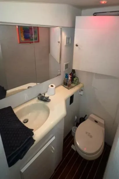 Slide: The Image of Bathroom interior of a 2000 Viking 50 Express yacht with sink and toilet. - 14