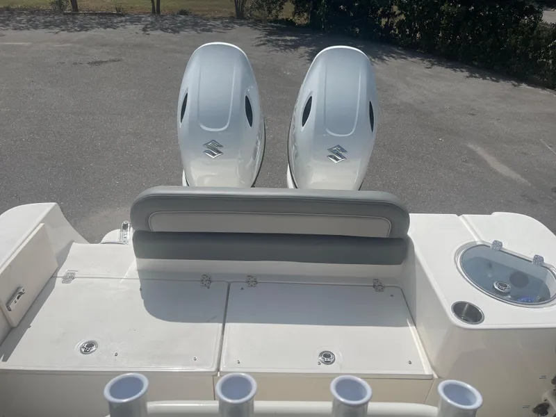 Slide: The Image of 2024 Sea Born LX 24 boat with dual outboard engines and fishing rod holders. - 12