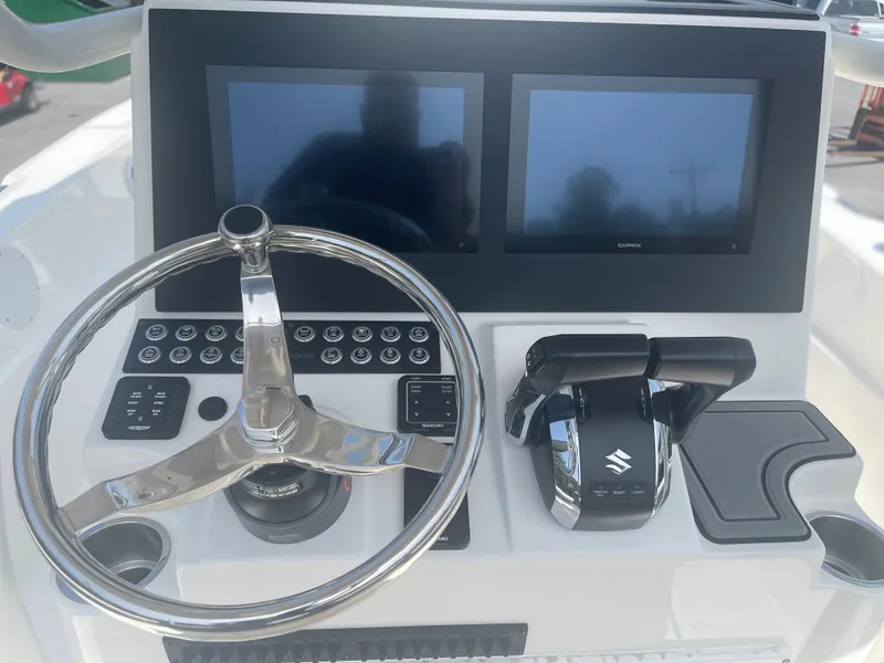 Slide: The Image of 2024 Sea Born LX 24 boat dashboard with dual screens and steering wheel. - 6
