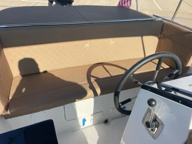 Slide: The Image of 2023 Maxima 620 Retro boat interior with tan seating and steering wheel. - 10